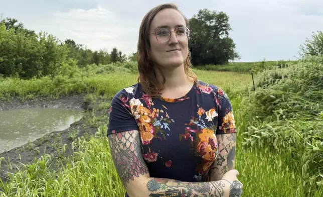 LeAnne Withrow, a transgender federal worker who has filed a class action lawsuit challenging a Trump administration policy prohibiting transgender federal employees from using restrooms aligned with their gender, poses for a photo at her home outside Springfield, Ill., July 30, 2025. (AP Photo/Claire Savage)