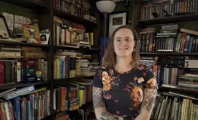 LeAnne Withrow, a transgender federal worker who has filed a class action lawsuit challenging a Trump administration policy prohibiting transgender federal employees from using restrooms aligned with their gender, poses for a photo at her home outside Springfield, Ill., July 30, 2025. (AP Photo/Claire Savage)