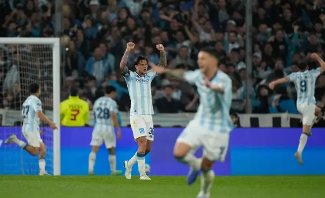 Bruno Zuculini of Argentina's Racing Club, center, celebrates after teammate Santiago Solari scored his side's opening goal against Argentina's Velez Sarsfield during a Copa Libertadores quarterfinal second leg soccer match at Presidente Peron stadium in Avellaneda, Argentina, Tuesday, Sept. 23, 2025. (AP Photo/Gustavo Garello)