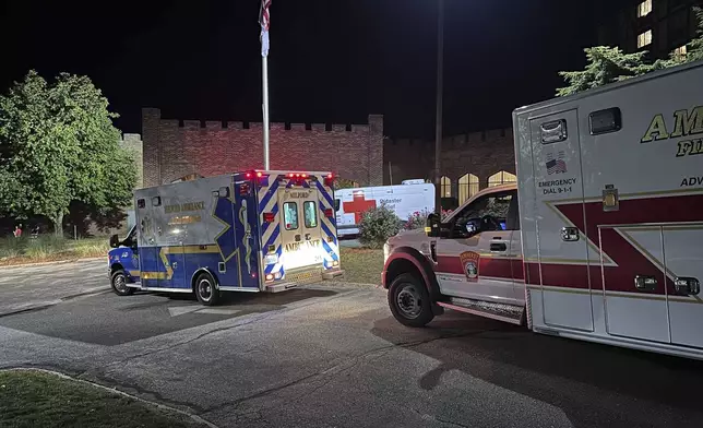 Ambulances are parked outside a hotel that is acting as a reunification center after a shooting at a country club in Nashua, New Hampshire, Saturday, Sept. 20, 2025. (AP Photo/Michael Casey)