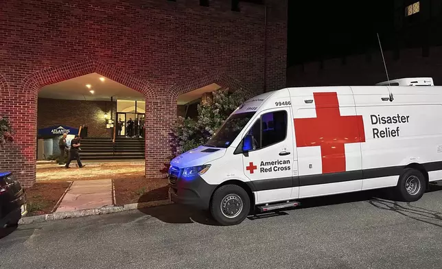 An American Red Cross Disaster Relief van is parked outside a hotel that is acting as a reunification center after a shooting at a country club in Nashua, New Hampshire, Saturday, Sept. 20, 2025. (AP Photo/Michael Casey)