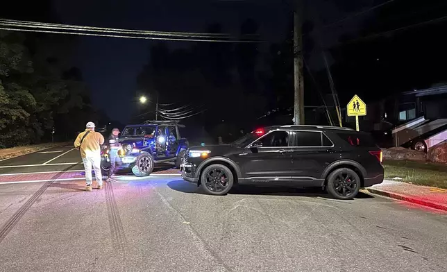 Police block a road to a country club where a shooting happened at Sky Meadow Country Club in Nashua, New Hampshire, Saturday, Sept. 20, 2025. (AP Photo/Michael Casey)