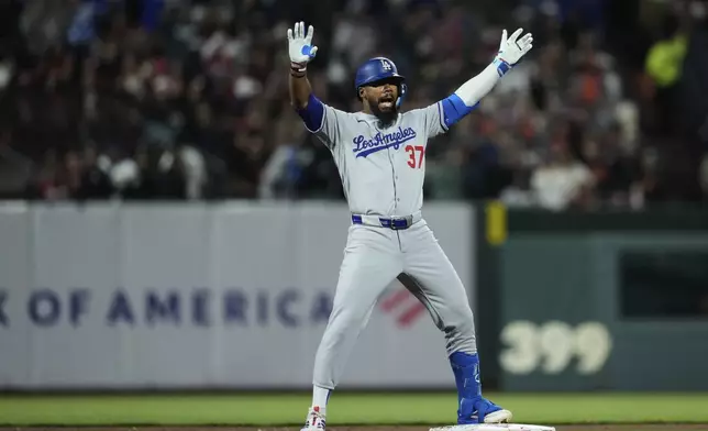 Los Angeles Dodgers' Teoscar Hernández celebrates after hitting a two-run double during the fifth inning of a baseball game against the San Francisco Giants, Saturday, Sept. 13, 2025, in San Francisco. (AP Photo/Godofredo A. Vásquez)
