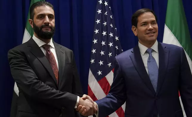 Secretary of State Marco Rubio shakes hands with Syrian interim President Ahmad al-Sharaa at the Lotte New York Palace Hotel, on the sidelines of the 80th United Nations General Assembly at the United Nations headquarters, Monday, Sept. 22, 2025. (Bing Guan/Pool Photo via AP)