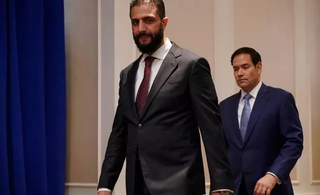 Secretary of State Marco Rubio, right, and Syrian interim President Ahmad al-Sharaa arrive ahead of a meeting at the Lotte New York Palace Hotel, on the sidelines of the 80th United Nations General Assembly at the United Nations headquarters, Monday, Sept. 22, 2025. (Bing Guan/Pool Photo via AP)