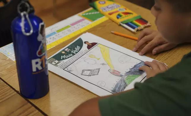 Mateo Jones, a fifth-grade student at St. John Berchmans' school draws a picture of Blessed Carlo Acutis, who will be canonized a saint by Pope Leo XIV, during a class activity on Wednesday, Sept. 3, 2025, in Chicago. (AP Photo/Jessie Wardarski)