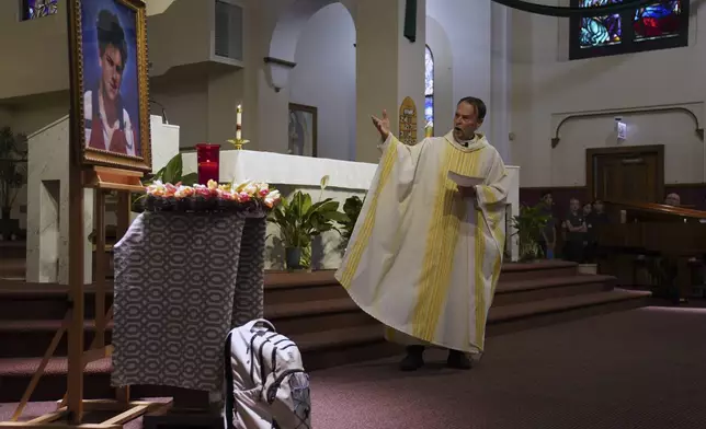 The Rev. Ed Howe, the pastor at Blessed Carlo Acutis Parish in Chicago's Northwest Side, leads a Mass themed for Acutis, who will be canonized a saint by Pope Leo XIV, at the parish church on Wednesday, Sept. 3, 2025, in Chicago. (AP Photo/Jessie Wardarski)