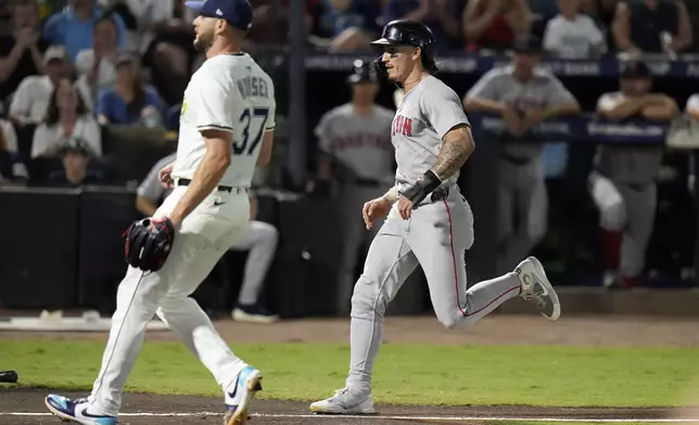 Boston Red Sox's Jarren Duran scores on a wild pitch by Tampa Bay Rays pitcher Adrian Houser (37) during the third inning of a baseball game Saturday, Sept. 20, 2025, in Tampa, Fla. (AP Photo/Chris O'Meara)