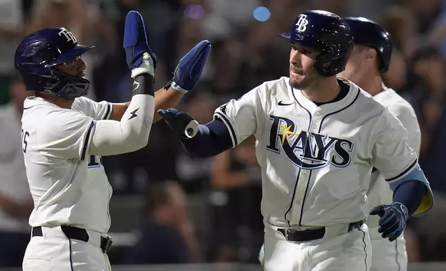Tampa Bay Rays' Nick Fortes, right, celebrates his three-run home run off Seattle Mariners pitcher Luis Castillo with Richie Palacios, left, during the second inning of a baseball game Monday, Sept. 1, 2025, in Tampa, Fla. (AP Photo/Chris O'Meara)