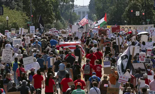 Demonstrators protest against President Donald Trump's deployment of federal law enforcement and National Guard troops in Washington during a march on Saturday, Sept. 6, 2025. (AP Photo/Jose Luis Magana)