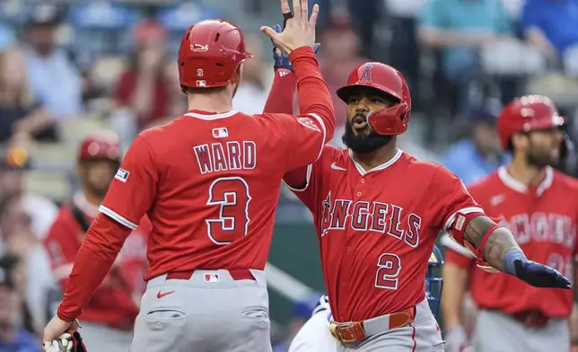 Los Angeles Angels' Luis Rengifo (2) celebrates with Taylor Ward (3) after hitting a three-run home run during the first inning of a baseball game against the Kansas City Royals, Thursday, Sept. 4, 2025, in Kansas City, Mo. (AP Photo/Charlie Riedel)