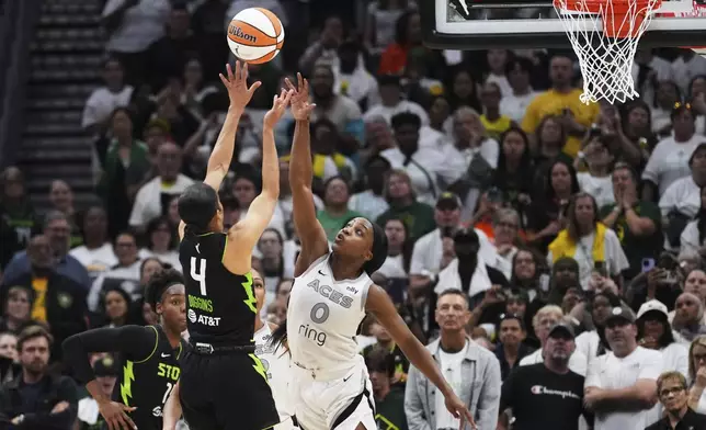 Seattle Storm guard Skylar Diggins (4) makes a shot over Las Vegas Aces guard Jackie Young (0) to give the Storm the lead during the second half of Game 2 in the first round of the WNBA basketball playoffs Tuesday, Sept. 16, 2025, in Seattle. (AP Photo/Lindsey Wasson)