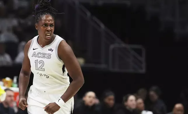 Las Vegas Aces guard Chelsea Gray reacts after a basket against the Seattle Storm during the first half of Game 2 in the first round of the WNBA basketball playoffs Tuesday, Sept. 16, 2025, in Seattle. (AP Photo/Lindsey Wasson)