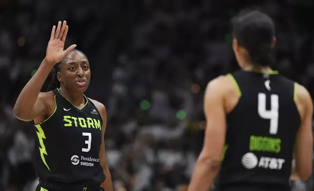 Seattle Storm forward Nneka Ogwumike greets guard Skylar Diggins (4) during the first half of Game 2 against the Las Vegas Aces in the first round of the WNBA basketball playoffs Tuesday, Sept. 16, 2025, in Seattle. (AP Photo/Lindsey Wasson)