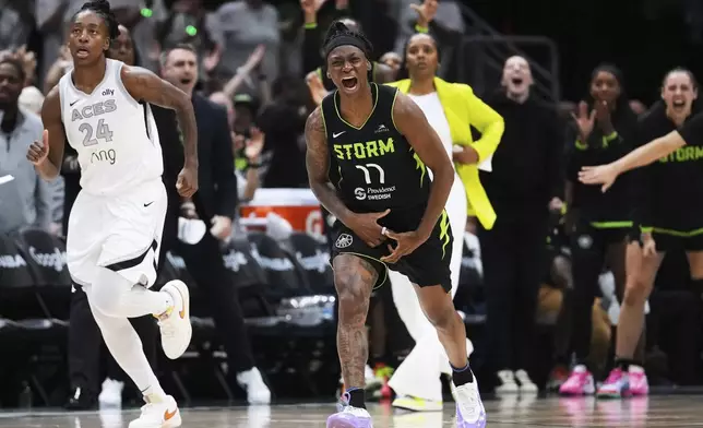 Seattle Storm guard Erica Wheeler (17) reacts after a basket as Las Vegas Aces guard Jewell Loyd (24) looks on during the second half of Game 2 in the first round of the WNBA basketball playoffs Tuesday, Sept. 16, 2025, in Seattle. (AP Photo/Lindsey Wasson)