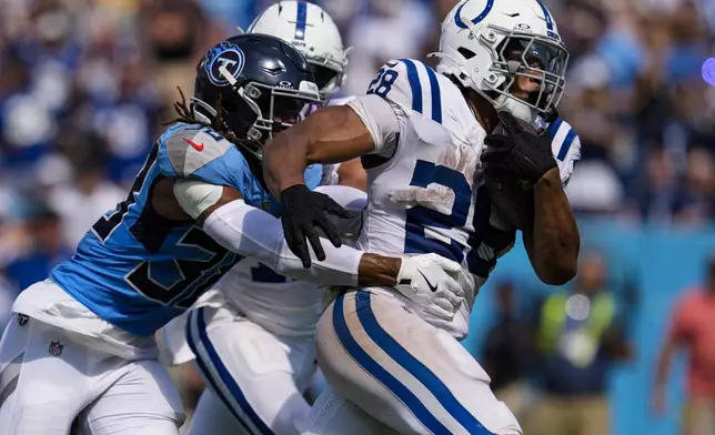 Tennessee Titans safety Quandre Diggs (28) runs past Tennessee Titans cornerback L'Jarius Sneed (38) for a touchdown during the second half of an NFL football game Sunday, Sept. 21, 2025, in Nashville, Tenn. (AP Photo/George Walker IV)