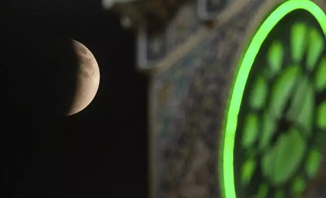 A partial lunar eclipse is seen in Najaf, Iraq, Sunday, Sept. 7, 2025. (AP Photo/Anmar Khalil)