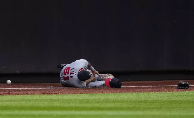 Washington Nationals outfielder Daylen Lile reacts after hitting a wall while failing to catch a fly ball by New York Mets' Cedric Mullins during the third inning of a baseball game against the New York Mets, Sunday, Sept. 21, 2025, in New York. (AP Photo/Yuki Iwamura)