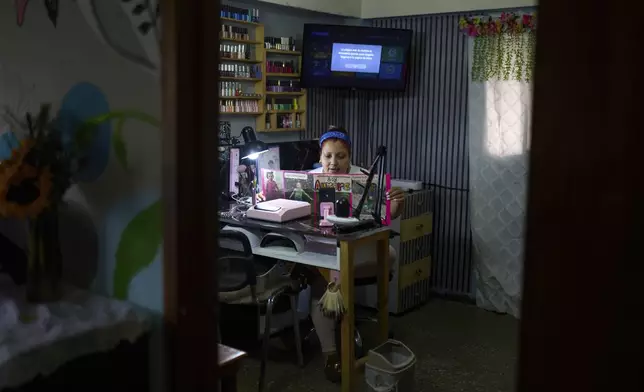 Syntia Caceres records a video for social media about her son who was detained in July in the U.S. and her four-year-old granddaughter Aurore who was subsequently placed in foster care in Georgia state, at her home in Caracas, Venezuela, Thursday, Sept. 4, 2025. (AP Photo/Ariana Cubillos)