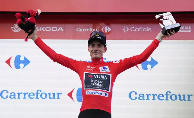Danish cyclist Jonas Vingegaard celebrates at the podium his first overall position at the end of the nineteenth stage of the Spanish La Vuelta cycling race, from Rueda to Guijuelo, Spain, Friday, Sept. 12, 2025. (AP Photo/Manu Fernandez)