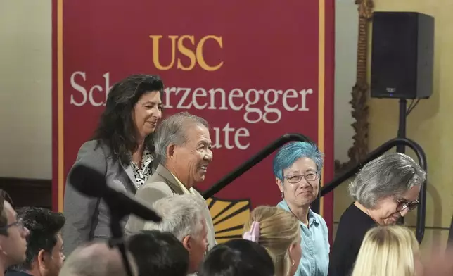 Members of the California Citizens Redistricting Commission, from left, Jodie Filkins, Peter Yao, Cynthia Dai, and Jeanne Raya, are introduced by former California Gov. Arnold Schwarzenegger during a talk with University of Southern California interim president Beong-Soo Kim on a conversation on democracy and Schwarzenegger's opposition to Proposition 50, a California ballot measure to redraw U.S. House maps to boost Democrats, at the USC campus in Los Angeles, Monday, Sept. 15, 2025. (AP Photo/Damian Dovarganes)