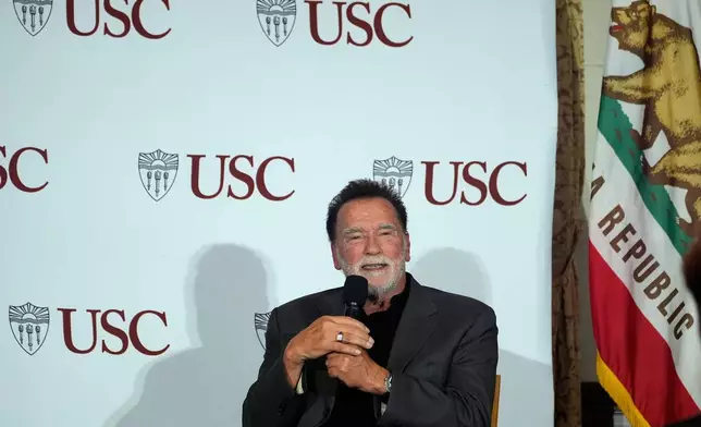 Former California Gov. Arnold Schwarzenegger, right, expresses his opposition to Proposition 50, a California ballot measure to redraw U.S. House maps to boost Democrats, during a conversation with University of Southern California interim president Beong-Soo Kim, not shown, on democracy at the USC campus in Los Angeles, Monday, Sept. 15, 2025 (AP Photo/Damian Dovarganes)