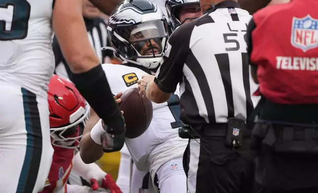 Philadelphia Eagles quarterback Jalen Hurts gets up off the turf after scoring a touchdown during the second half of an NFL football game against the Kansas City Chiefs Sunday, Sept. 14, 2025, in Kansas City, Mo. (AP Photo/Charlie Riedel)
