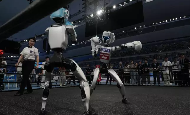Robots compete at the Free Combat event of the World Humanoid Robot Games in Beijing, China, Aug. 15, 2025. (AP Photo/Ng Han Guan)