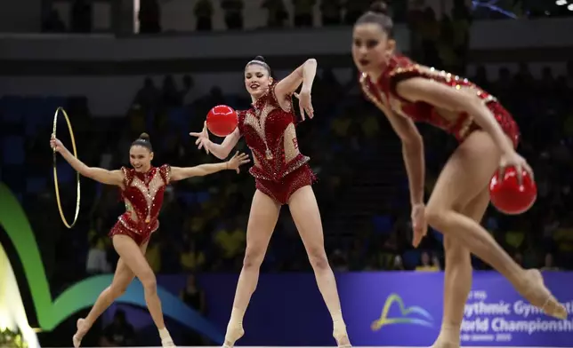 Brazil's team competes with hoops and balls during the group all-around final at the 41st FIG Rhythmic Gymnastics World Championships in Rio de Janeiro, Aug. 23, 2025. (AP Photo/Bruna Prado)