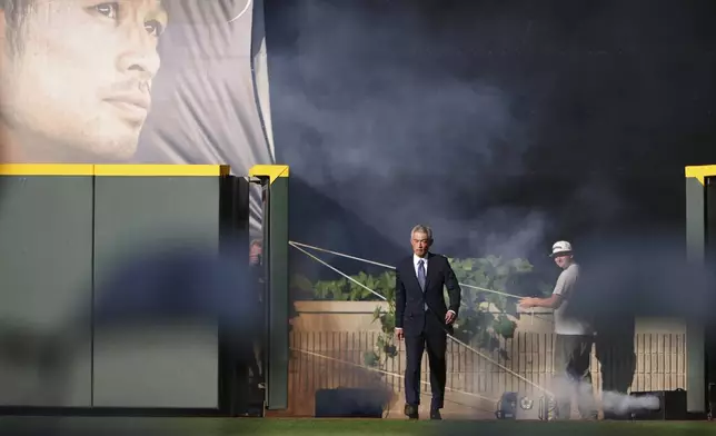 Former Seattle Mariners right fielder Ichiro Suzuki walks on to the field for his jersey retirement ceremony in Seattle, Aug. 9, 2025, before a baseball game between the Mariners and the Tampa Bay Rays. (AP Photo/Lindsey Wasson)