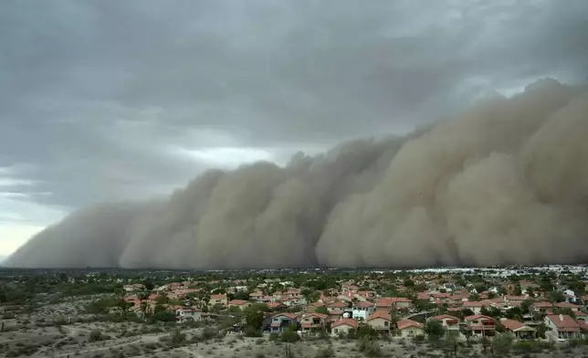 A giant dust storm approaches the metro area of Phoenix, Arizona, as a monsoon storm pushes the dust into the air, Aug. 25, 2025. (AP Photo/Ross D. Franklin)