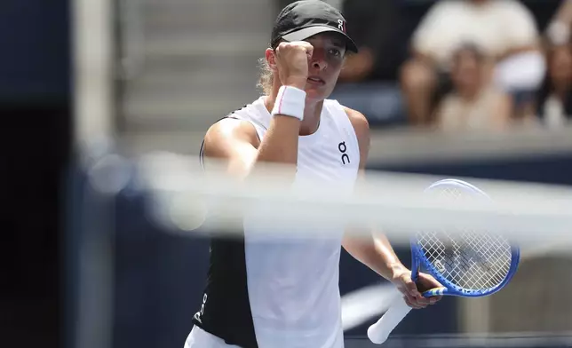 Iga Swiatek, of Poland, reacts during a match against Ekaterina Alexandrova, of Russia, in the fourth round of the US Open tennis championships, Monday, Sept. 1, 2025, in New York. (AP Photo/Heather Khalifa)