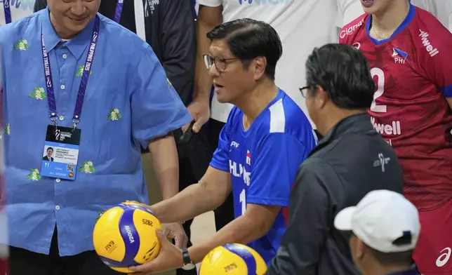 FILE - Philippine President Ferdinand Marcos Jr. center, tosses the ceremonial ball during the opening of the 2025 FIVB Volleyball Men's World Championship in Pasay, Philippines on Friday, Sept. 12, 2025. (AP Photo/Aaron Favila, File)