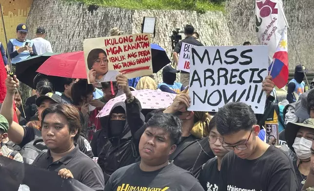 Protestors hold placards, one of them reads "Lock up the thieves and return the money the people’s money." as they hold a rally at the People Power Monument in Manila Saturday morning, Sept. 13, 2025, over allegations of massive corruption in flood control projects that have implicated several congressmen and public works officials and sparked pockets of street protests. (AP Photo/Joeal Calupitan)