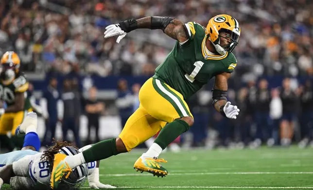 Green Bay Packers defensive end Micah Parsons (1) rushes after getting past Dallas Cowboys offensive tackle Tyler Guyton (60) in the first half of an NFL football game Sunday, Sept. 28, 2025, in Arlington, Texas. (AP Photo/Jessica Tobias)