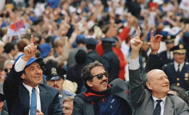 FILE - New York Gov. Mario Cuomo, left, New York Mets Manager Davey Johnson, center, and New York Mayor Ed Koch, raise their hands signaling "number one" during a tickertape parade for the World Series winners in downtown Manhattan, New York, Oct. 28, 1986, in New York. (AP Photo/Mario Cabrera, File)