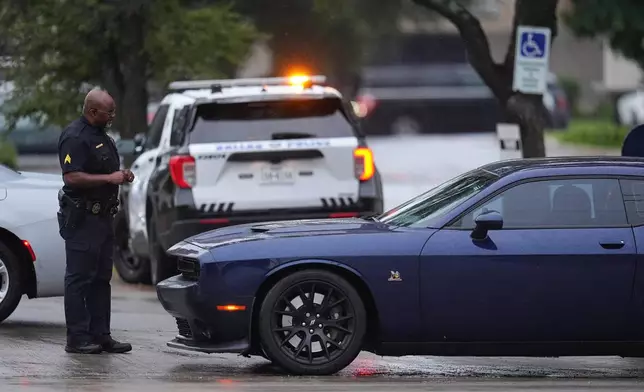 Police block off the street close to a U.S. Immigration and Customs Enforcement office after a reported shooting, in Dallas on Wednesday, Sept. 24, 2025. (AP Photo/Julio Cortez)