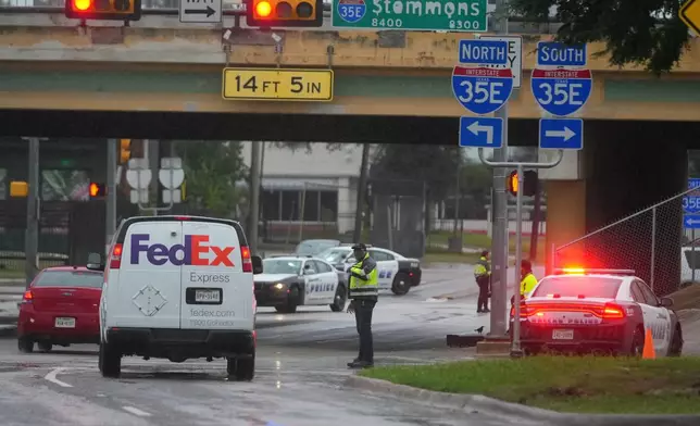 Police block off the street close to a U.S. Immigration and Customs Enforcement office after a reported shooting, in Dallas on Wednesday, Sept. 24, 2025. (AP Photo/Julio Cortez)