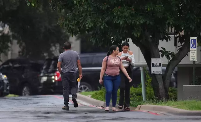 People who had appointments at a U.S. Immigration and Customs Enforcement office are turned away after a reported shooting in the facility in Dallas on Wednesday, Sept. 24, 2025. (AP Photo/Julio Cortez)