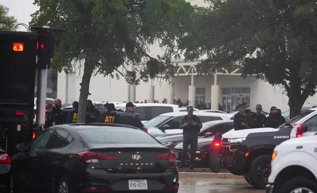 Law enforcement gather at a staging area close to a U.S. Immigration and Customs Enforcement office after a reported shooting, in Dallas on Wednesday, Sept. 24, 2025. (AP Photo/Julio Cortez)