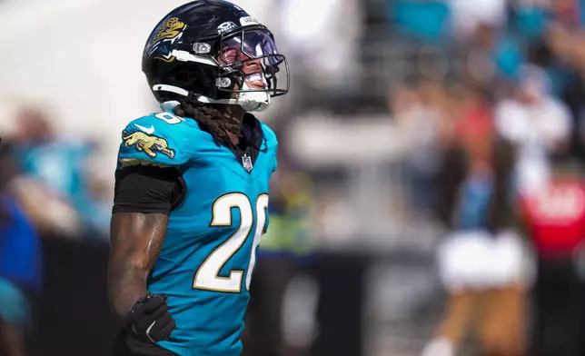 Jacksonville Jaguars safety Antonio Johnson reacts after making an interception on a pass by Houston Texans quarterback CJ. Stroud during the second half of an NFL football game Sunday, Sept. 21, 2025, in Jacksonville, Fla. (AP Photo/John Raoux)