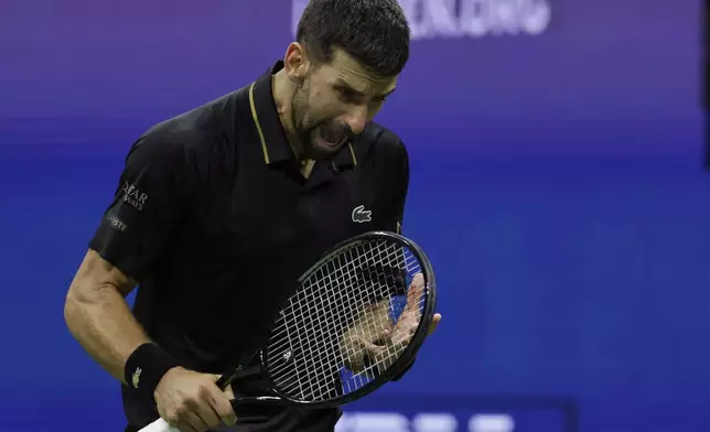 Novak Djokovic, of Serbia, reacts after losing a point against Taylor Fritz, of the United States, during the quarterfinal round of the U.S. Open tennis championships, Tuesday, Sept. 2, 2025, in New York. (AP Photo/Adam Hunger)