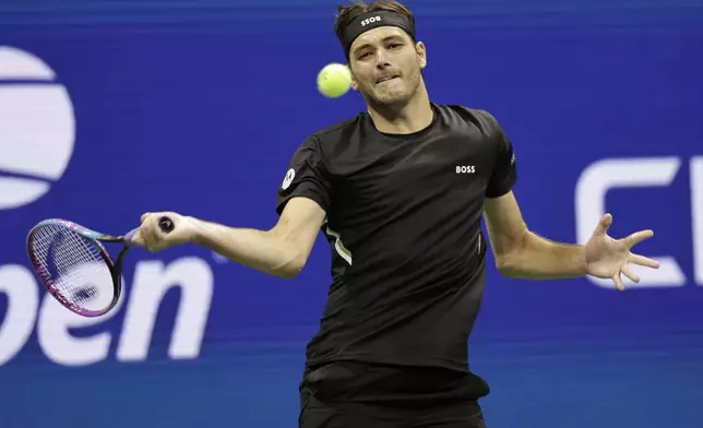 Taylor Fritz, of the United States, returns a shot against Novak Djokovic, of Serbia, during the quarterfinal round of the U.S. Open tennis championships, Tuesday, Sept. 2, 2025, in New York. (AP Photo/Adam Hunger)
