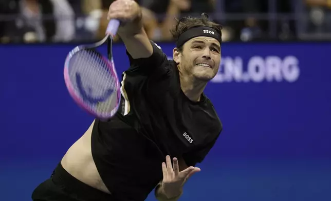 Taylor Fritz, of the United States, serves against Novak Djokovic, of Serbia, during the quarterfinal round of the U.S. Open tennis championships, Tuesday, Sept. 2, 2025, in New York. (AP Photo/Adam Hunger)