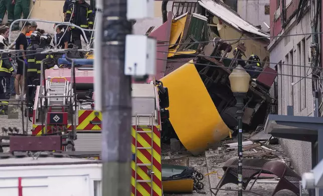 Emergency teams work at the site of a derailed electric streetcar in Lisbon, Portugal, Wednesday, Sept. 3, 2025. (AP Photo/Armando Franca)