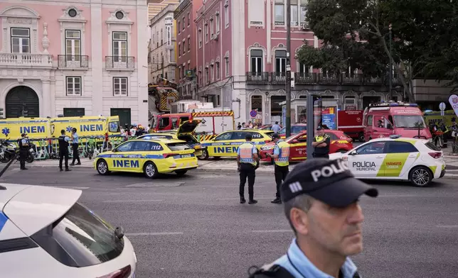 Emergency teams work at the site of a derailed electric streetcar in Lisbon, Portugal, Wednesday, Sept. 3, 2025. (AP Photo/Armando Franca)