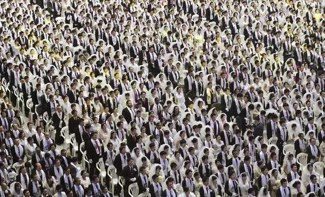 FILE - Couples from around the world participate in a mass wedding ceremony at the Cheong Shim Peace World Center in Gapyeong, South Korea, on March 3, 2015. (AP Photo/Ahn Young-joon, File)