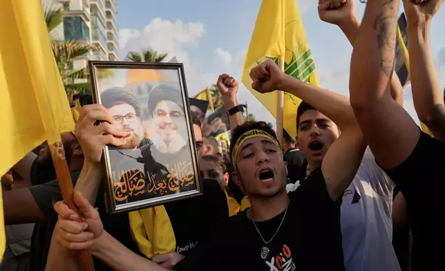 Hezbollah supporters shout slogans during an event commemorating the anniversary of the assassination of Hezbollah leader Sayyed Hassan Nasrallah in Beirut, Lebanon, Thursday, Sept. 25, 2025. (AP Photo/Hussein Malla)