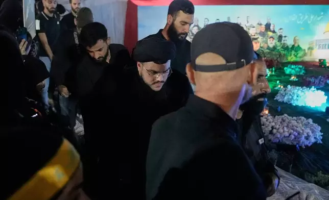 Mohammad Mahdi Nasrallah, center, son of former Hezbollah leader Hassan Nasrallah, arrives for a gathering at the site where his father was killed in Israeli airstrikes on Sept. 27, 2024, a day before the first anniversary of his death, in the Haret Hreik suburb south of Beirut, Lebanon, Friday, April 26, 2025. (AP Photo/Hassan Ammar)