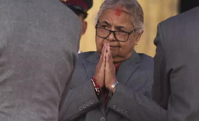 Nepal's new prime minister Sushila Karki greets ministers administered the oath of office by Nepalese President Ram Chandra Poudel at the presidential building in Kathmandu, Nepal, Monday, Sept. 15, 2025. (AP Photo/Niranjan Shrestha)